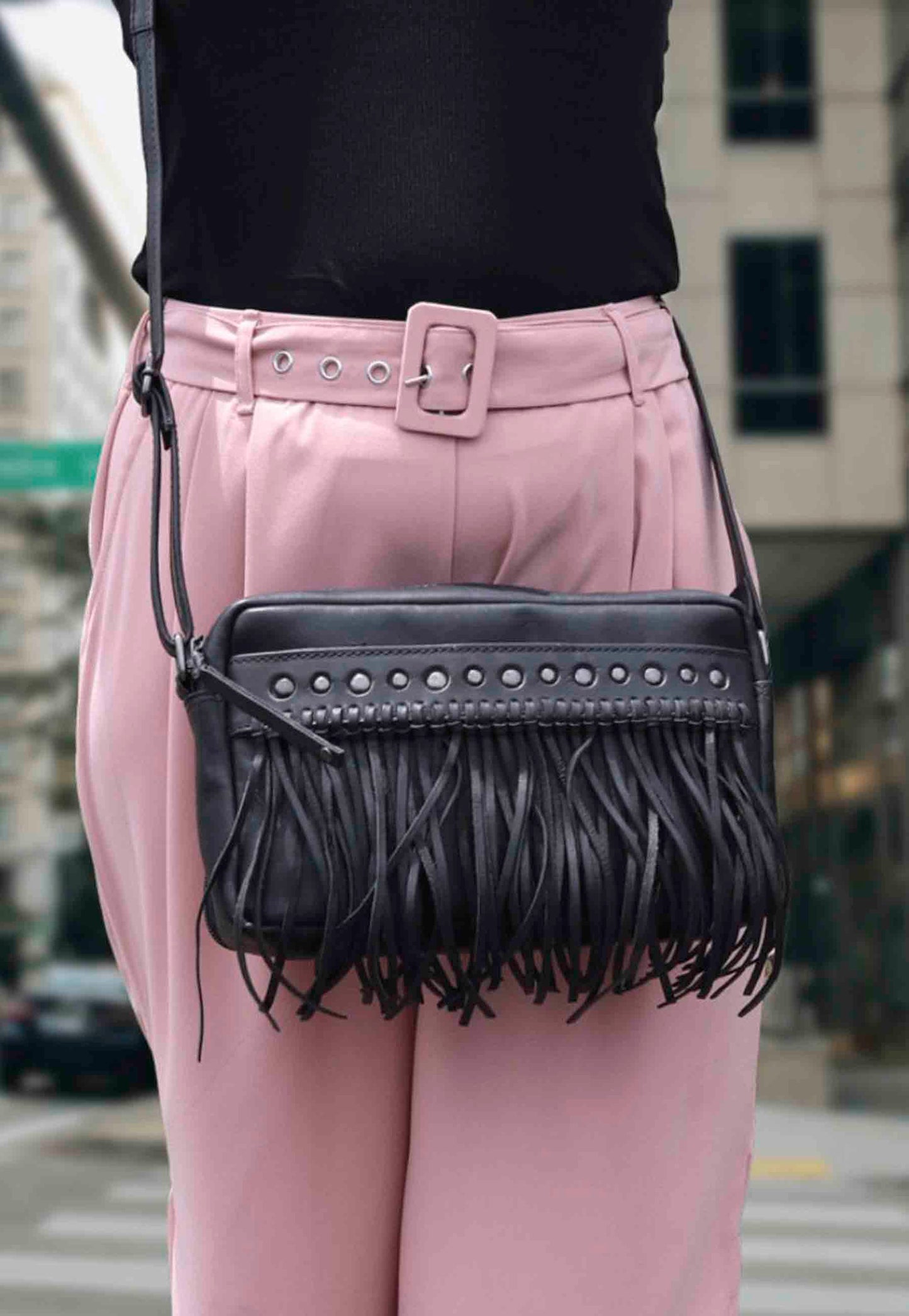 model in city showing conceal carry purse over shoulder