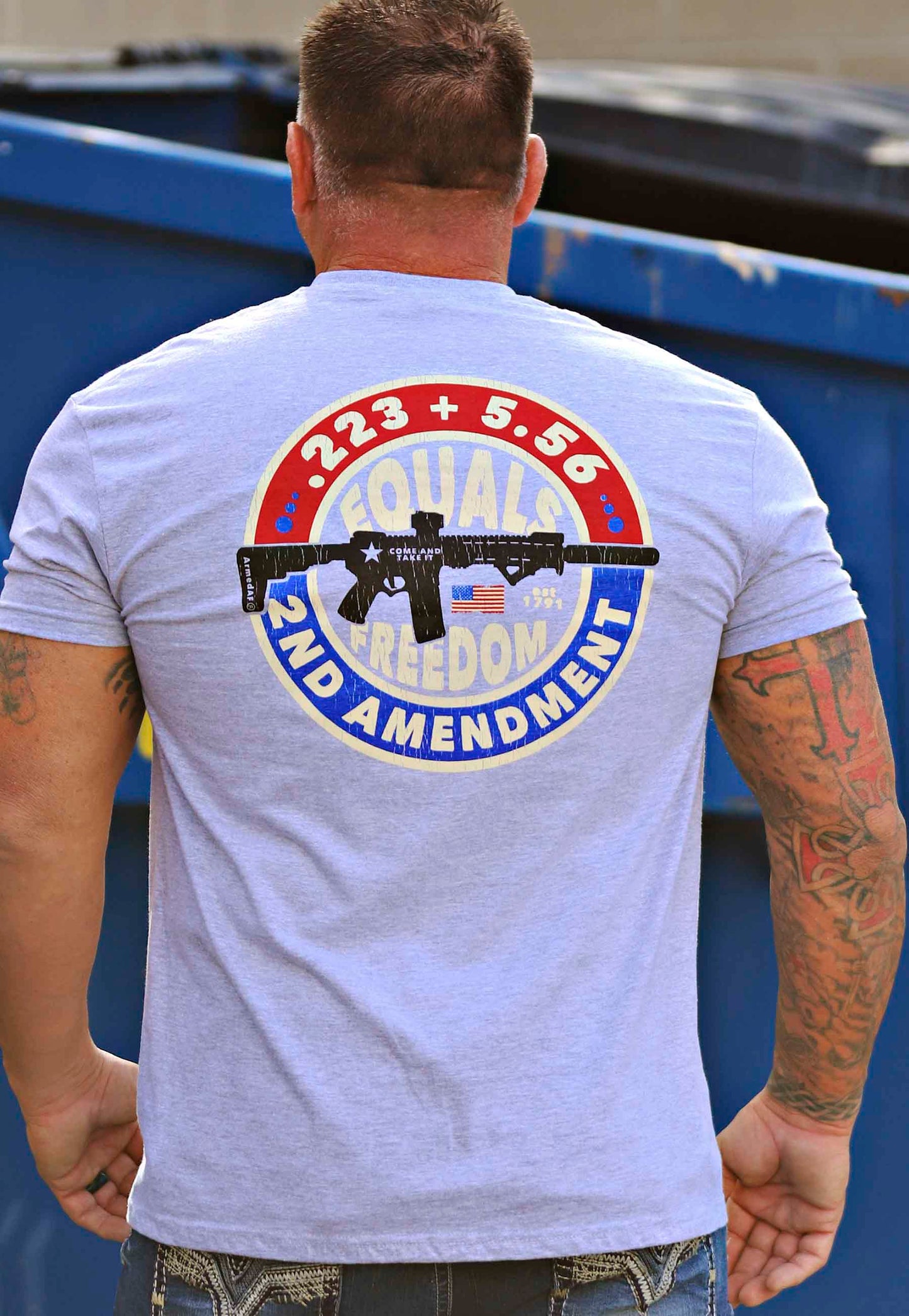 Gun math t-shirt on model near dumpster