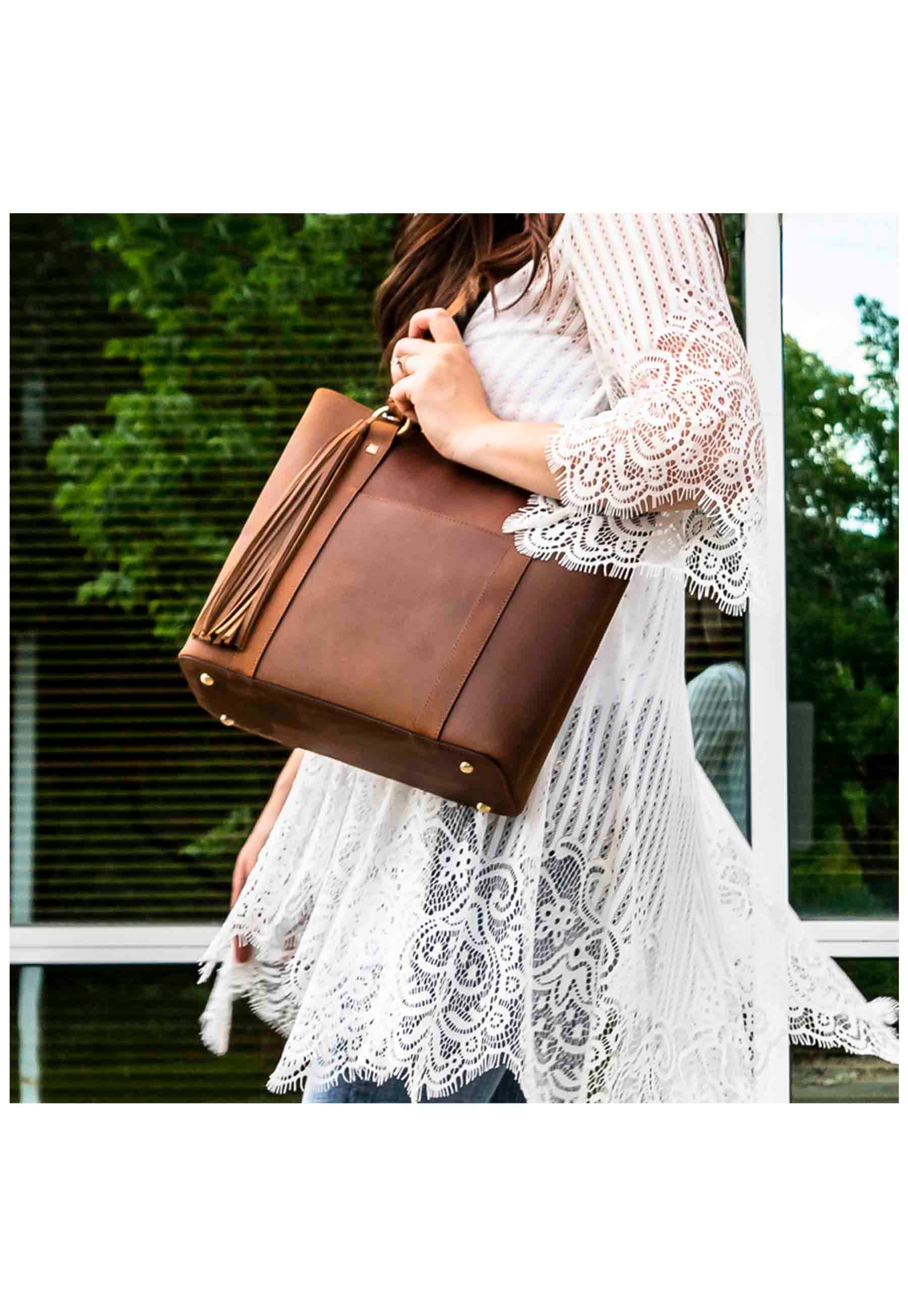 model carrying distressed brown leather conceal carry purse over shoulder