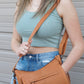 model with gun purse on shoulder