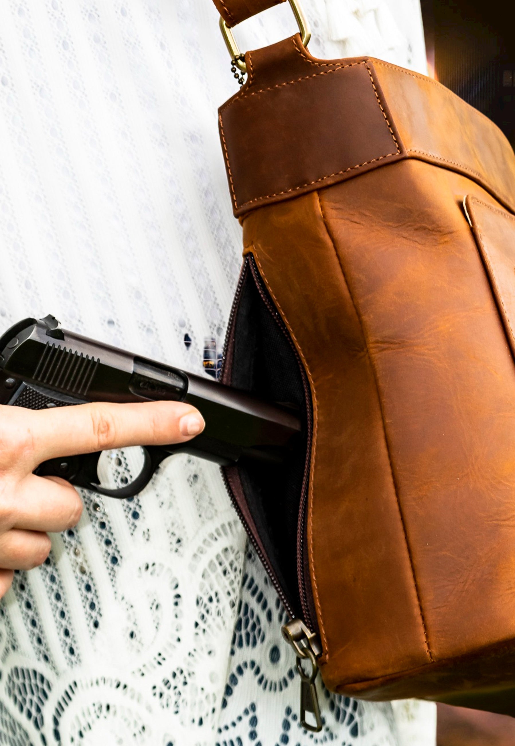 Model demonstrating 100% leather gun purse
