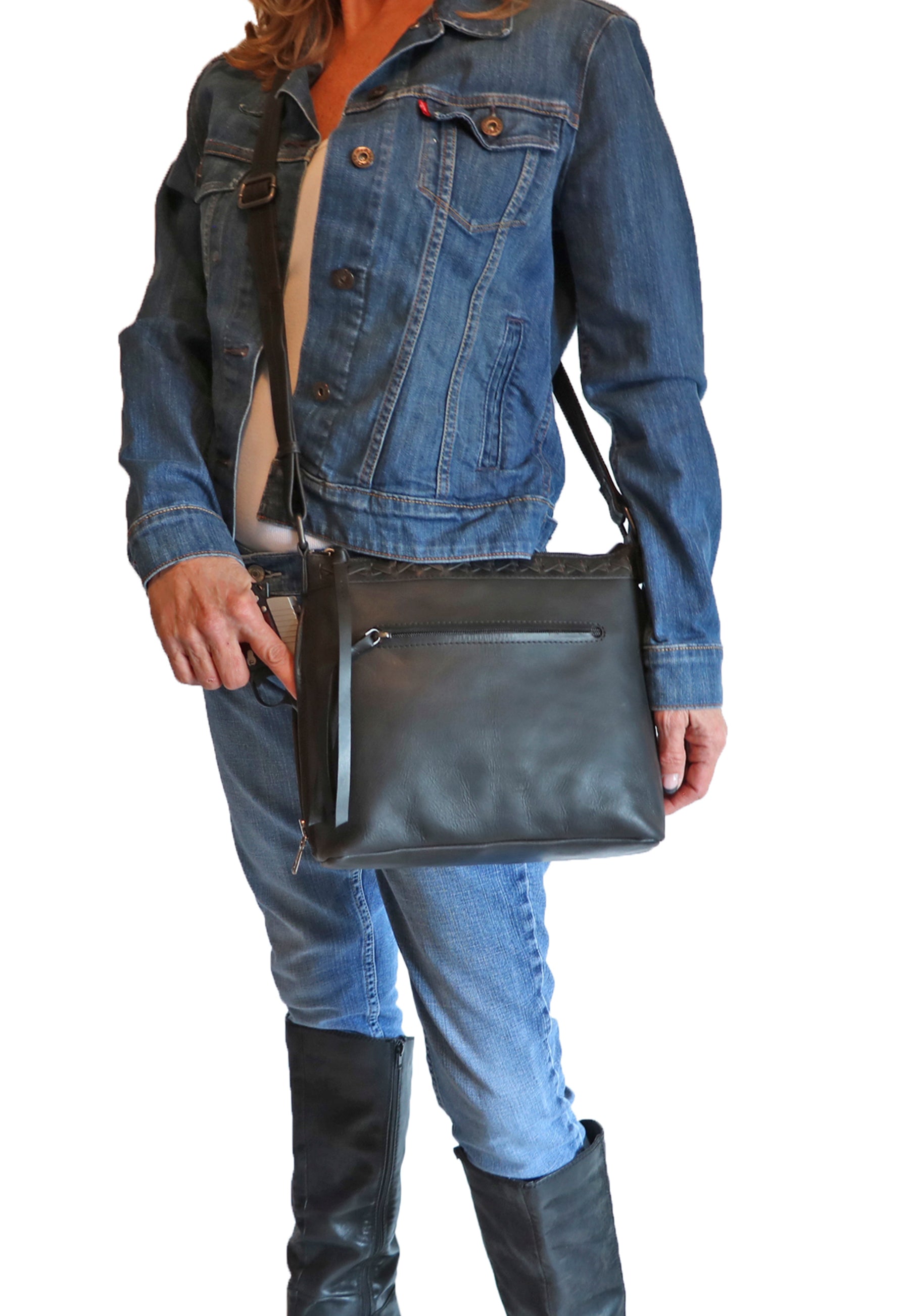Model demonstrating leather crossbody conceal carry bag with pistol