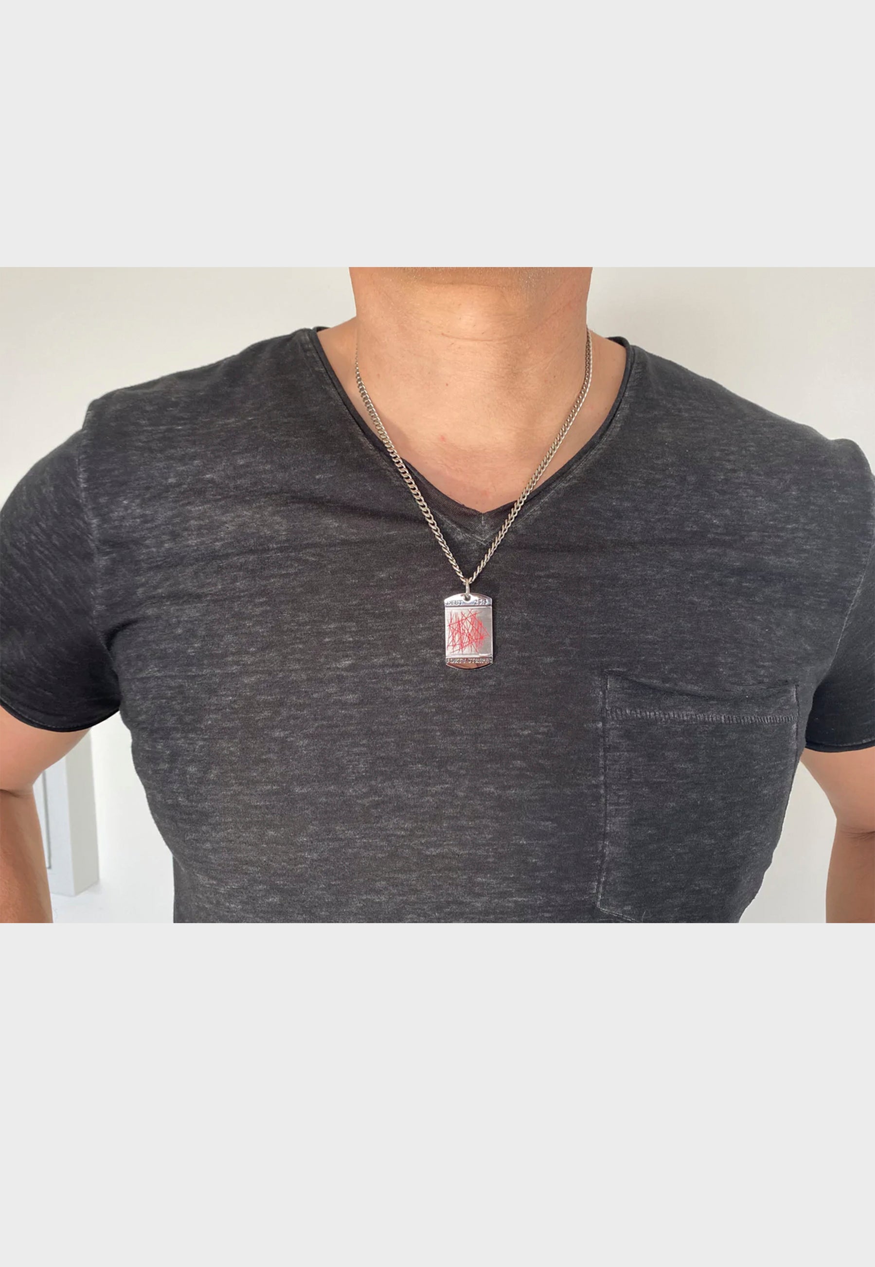 Man wearing Christian dogtag necklace
