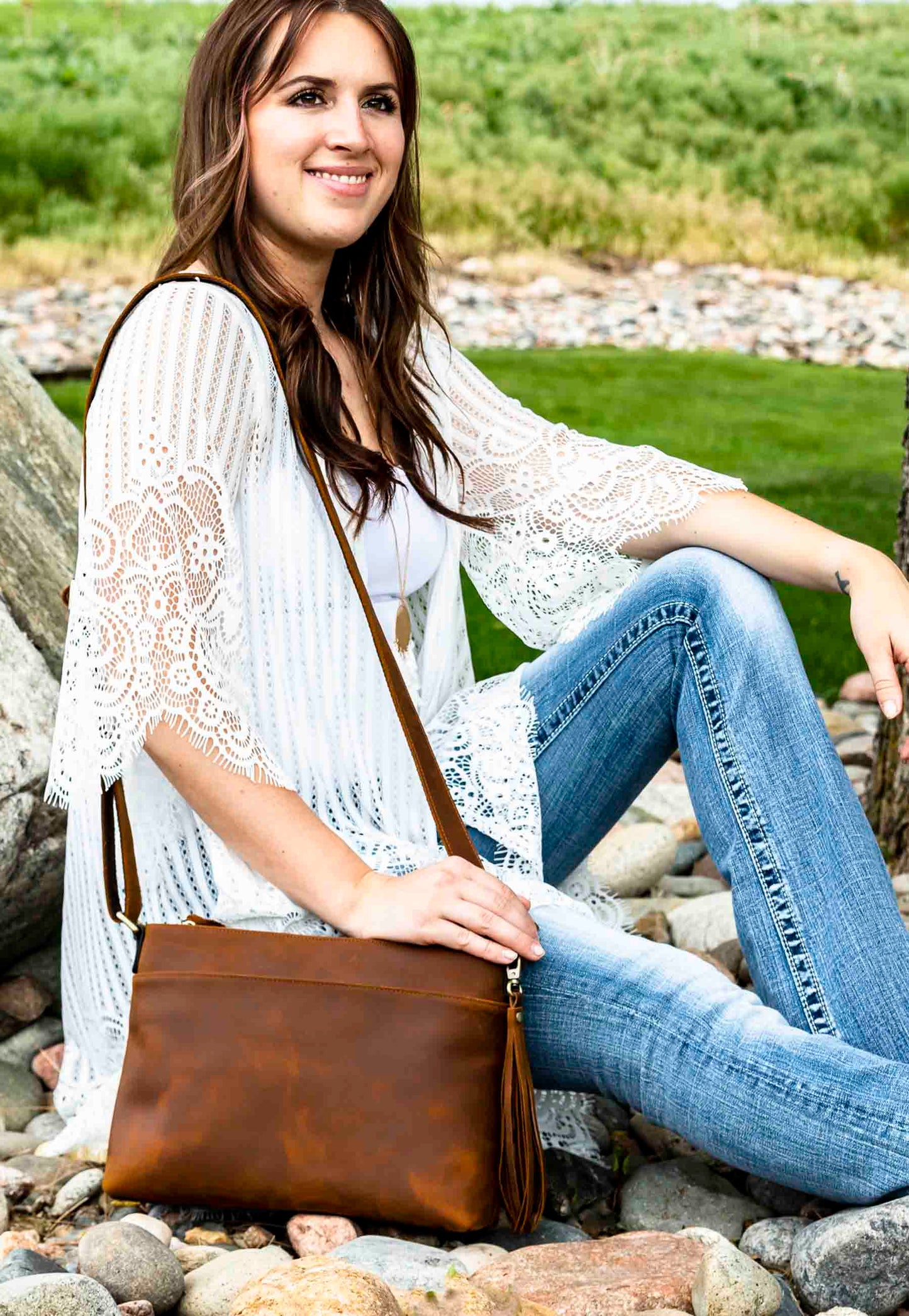 model posing with top grain leather pistol purse 