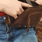 model pulling gun from leather fanny pack