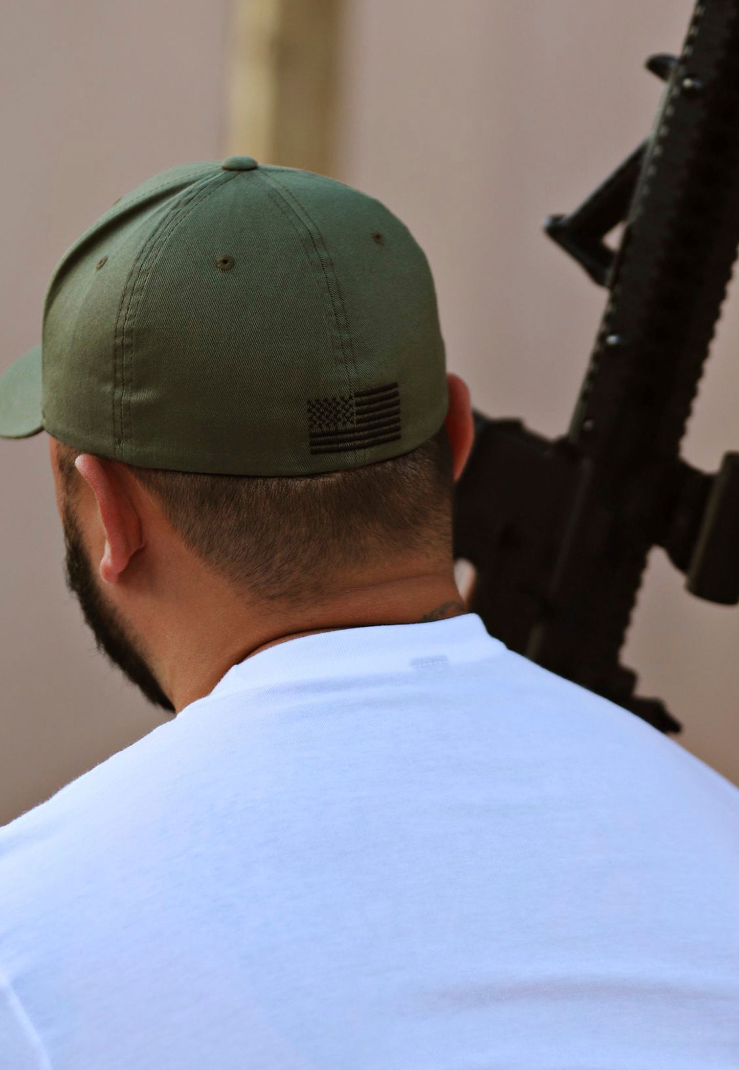 Rear view of ArmedAF® logo hat on model showing American flag